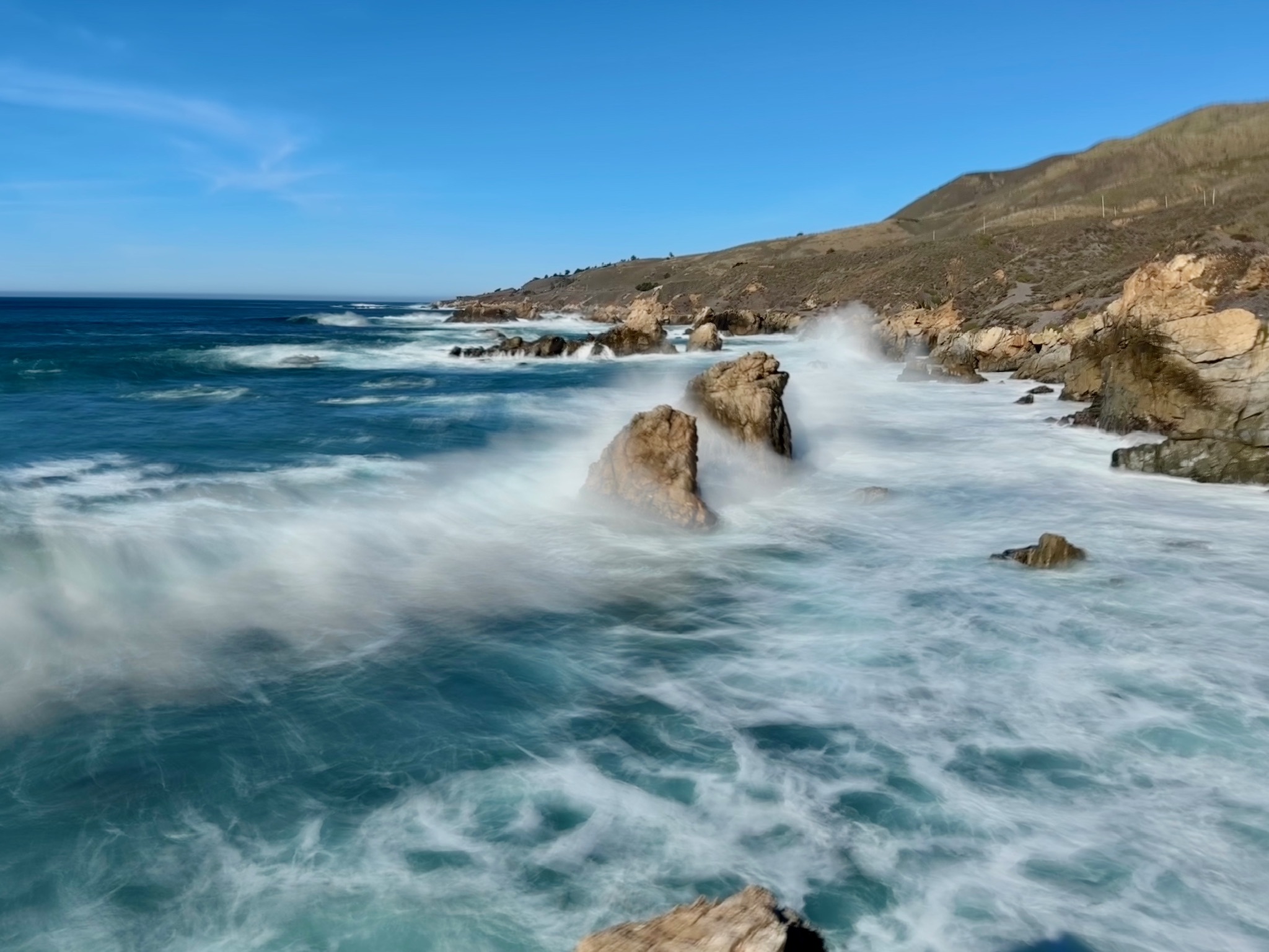 Waves crashing against rocks along the Pacific Coast